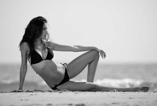 women, black bikinis, sand, sea, belly, monochrome, depth of field, looking away