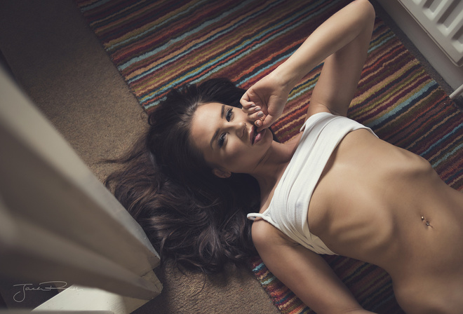 women, underboob, T-shirt, top view, belly, on the floor, pierced navel, ribs, Jack Russell, brunette, boobs, finger in mouth, lying on back, looking at viewer