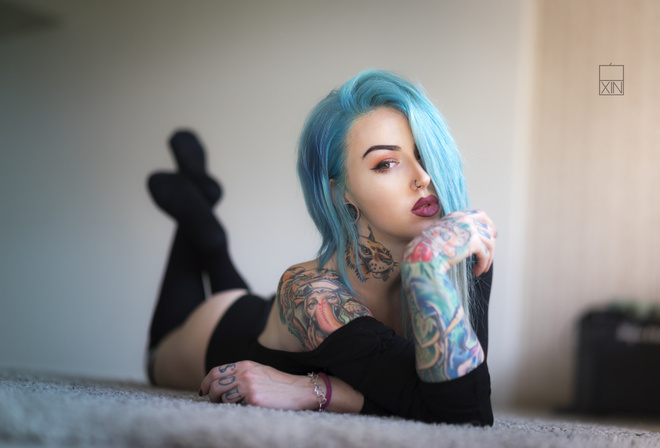 women, dyed hair, lying on front, tattoo, ass, black stockings, leotard, portrait, on the floor, nose rings, eyeliner, painted nails, depth of field