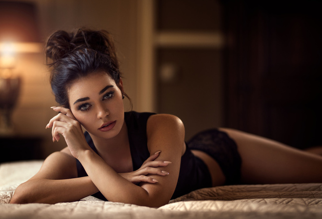 women, tanned, in bed, black lingerie, lying on front, depth of field