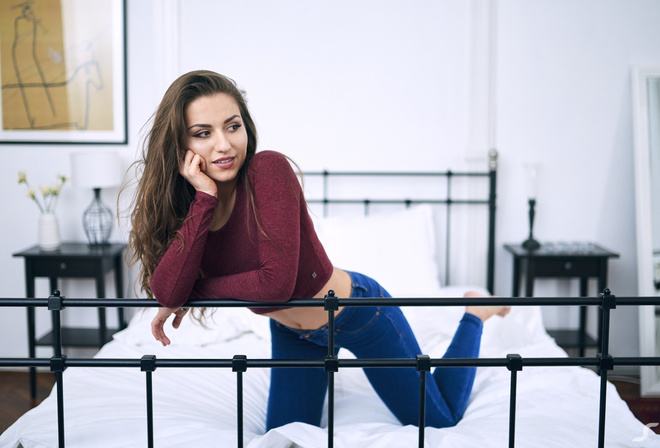 women, in bed, belly, jeans, pillow, kneeling, pink lipstick, brunette