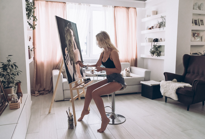 women, easel, blonde, sitting, jean shorts, dog, couch, plants, window, chair