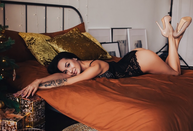 women, body lingerie, ass, lingerie, women indoors, Christmas Tree, smiling, feet in the air, high heels, black lingerie, pillow, lying on front, tattoo, brunette, Christmas, eyeliner, presents