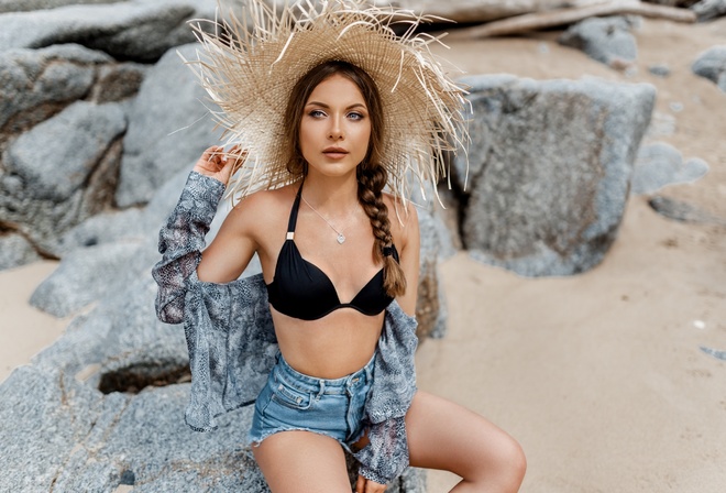 women, hat, bikini top, rocks, necklace, women outdoors, sand, sitting, brunette, belly, jean shorts