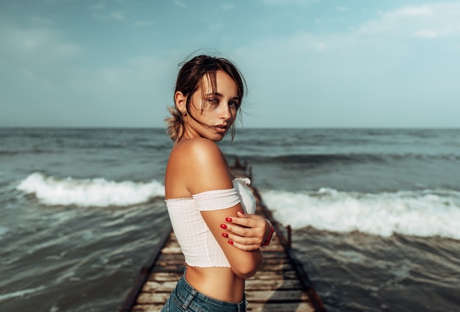 women, brunette, sea, women outdoors, jean shorts, red nails, pier, bare shoulders, watch, arms crossed, sky