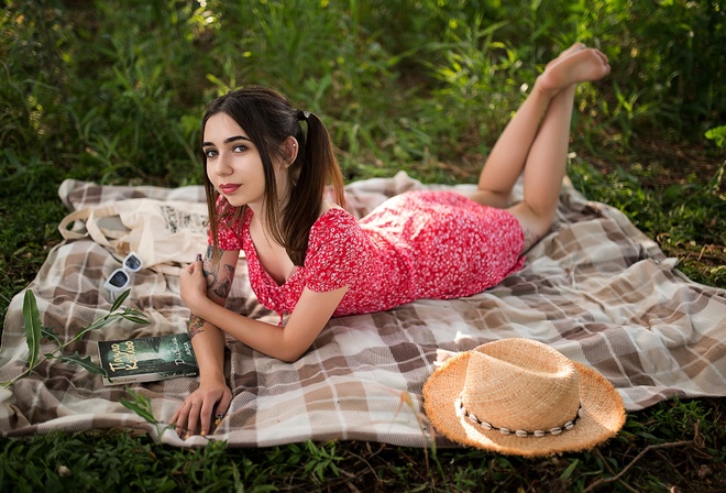 brunette, model, women, women outdoors, summer dress, tattoo, picnic, straw hat, sunglasses, glasses, lying on front, dress, barefoot, pierced ear, books, trees, grass, twintails