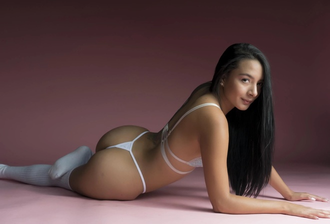 studio, brunette, ass, , women indoors, white panties, tattoo, lingerie, model, thigh-highs, hips, on the floor, pink background, long hair, white thong