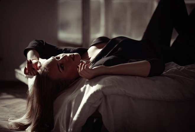 women indoors, in bed, blonde, , black pants, model, lying on back, jacket, black clothing, black jacket, red lipstick, makeup