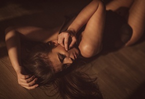 women, tanned, lying on back, closed eyes, depth of field, black lingerie, on the floor