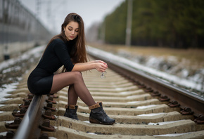 women, sitting, shoes, women outdoors, black clothing, long hair, railway, black skirts, glasses