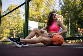 women, basketball court, sportswear, ball, women outdoors, sneakers, trees, sitting, belly, looking away