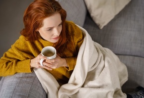 woman, comfortable couch, blanket, coffee