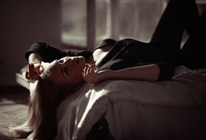 women indoors, in bed, blonde, , black pants, model, lying on back, jacket, black clothing, black jacket, red lipstick, makeup