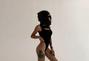 motorbike helmet, brunette , tattoo, model, hips, black bodysuit, ass, women indoors, blonde, simple background