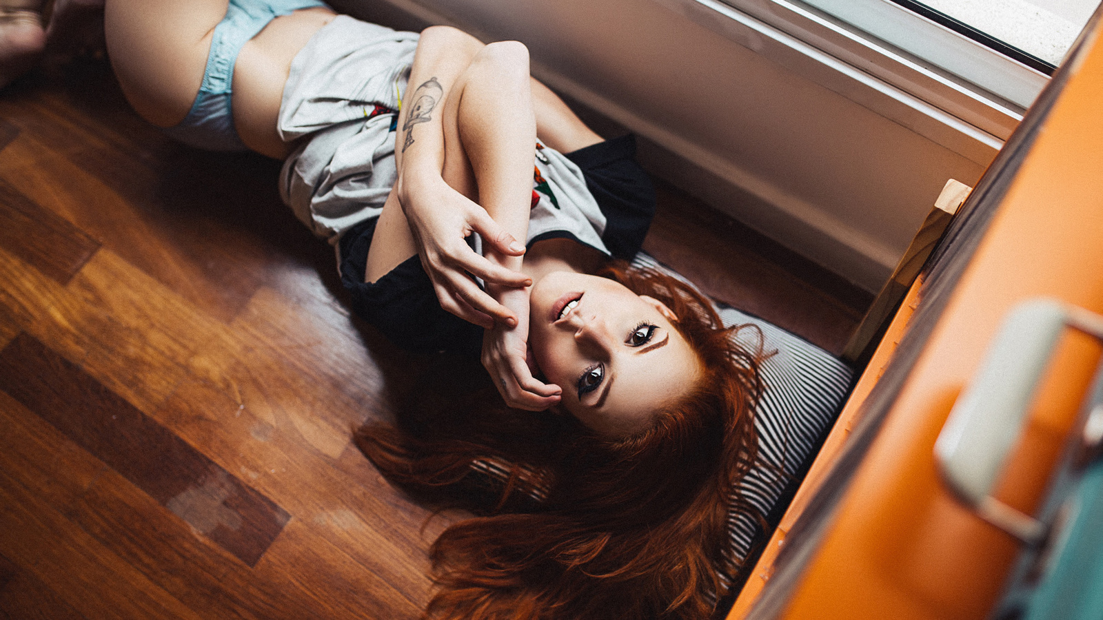 elisa rios, women, redhead, lingerie, thong, wooden surfac, eon the floor, looking at viewer, brunette, tattoo, henrique cesar, t-shirt