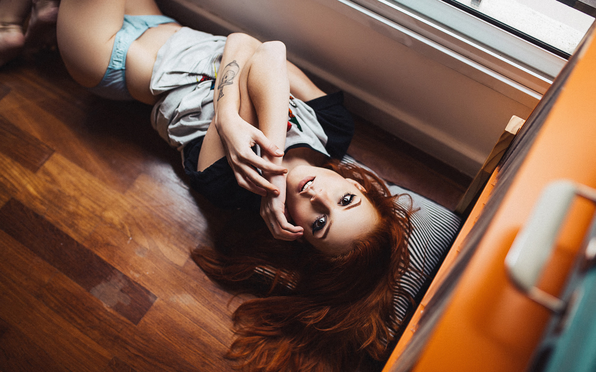 elisa rios, women, redhead, lingerie, thong, wooden surfac, eon the floor, looking at viewer, brunette, tattoo, henrique cesar, t-shirt