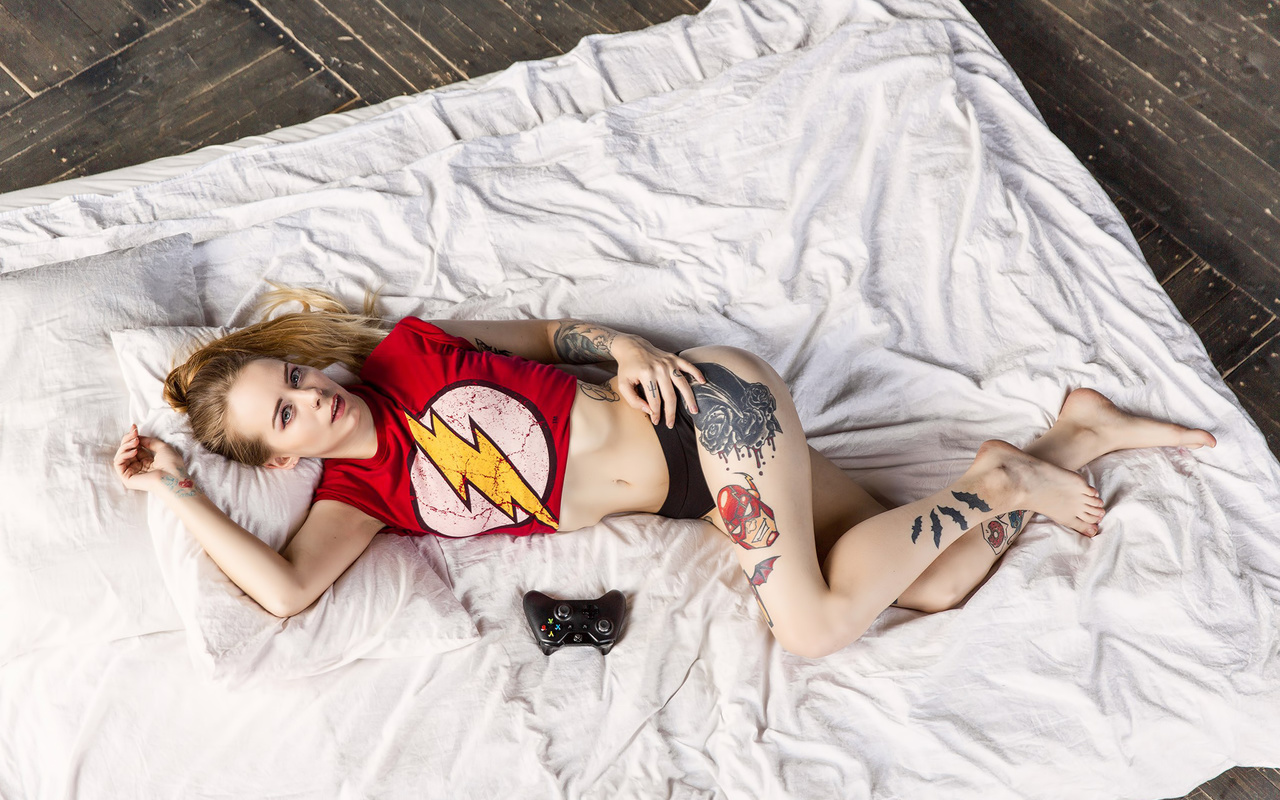 natalia shardina, women, blonde, t-shirt, tattoos, hands on hips, top view, wooden surface, belly, pale, short shorts, joystick, xbox 360, nose rings, ass, looking at viewer