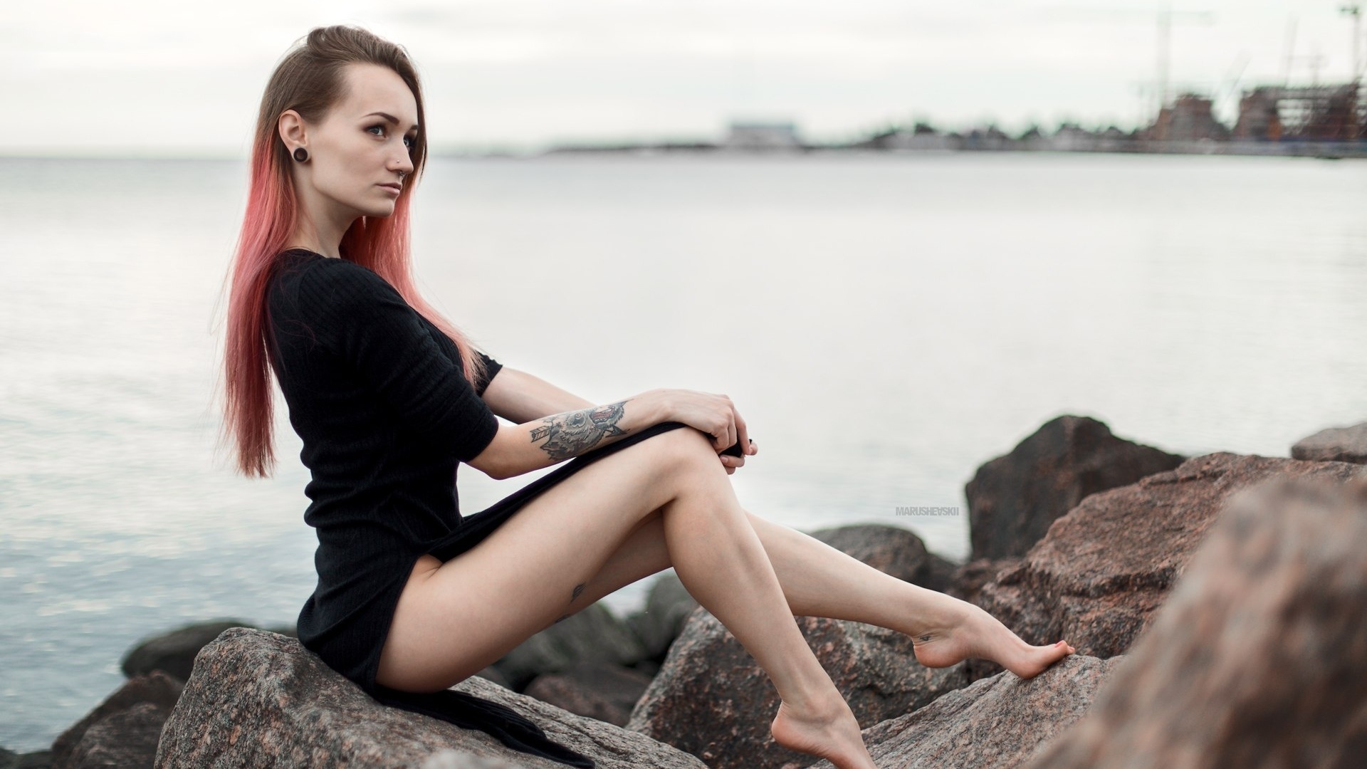 julia tyki, women, skinny, black dress, dyed hair, rocks, sea, tattoos, portrait, pierced nose, nose rings, long hair, sitting