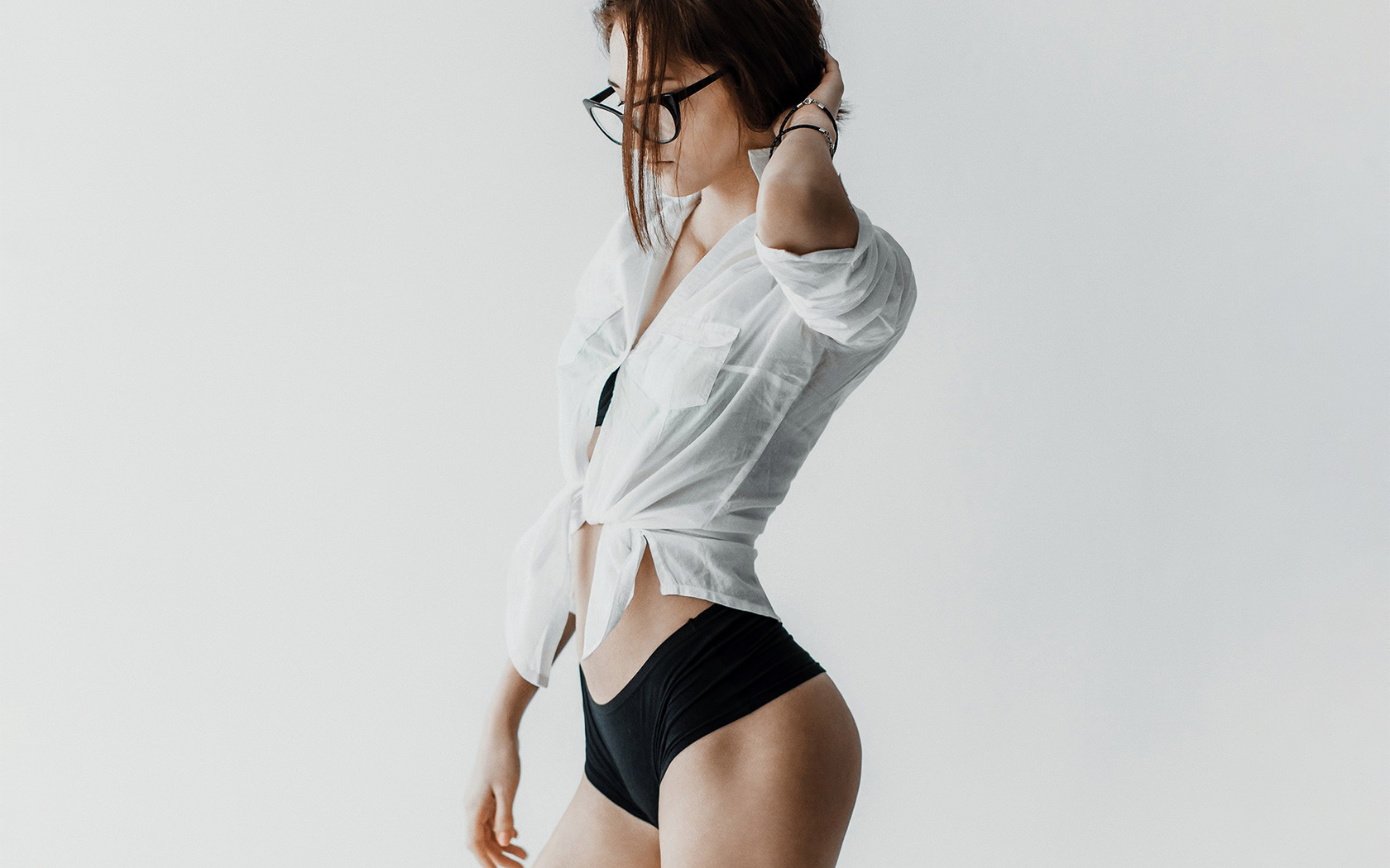 women, portrait, short shorts, short, skirt, belly, brunette, ass, women with glasses, glasses, see-through clothing, hands on head, simple background, white background, andrey popenko