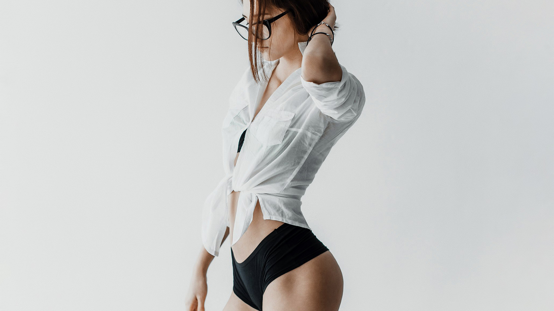 women, portrait, short shorts, short, skirt, belly, brunette, ass, women with glasses, glasses, see-through clothing, hands on head, simple background, white background, andrey popenko