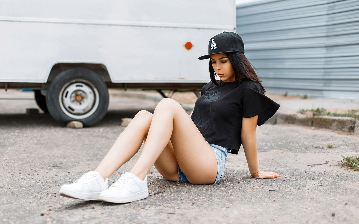 women, sitting, t-shirt, closed eyes, jean shorts, sneakers, baseball caps, women outdoors, 