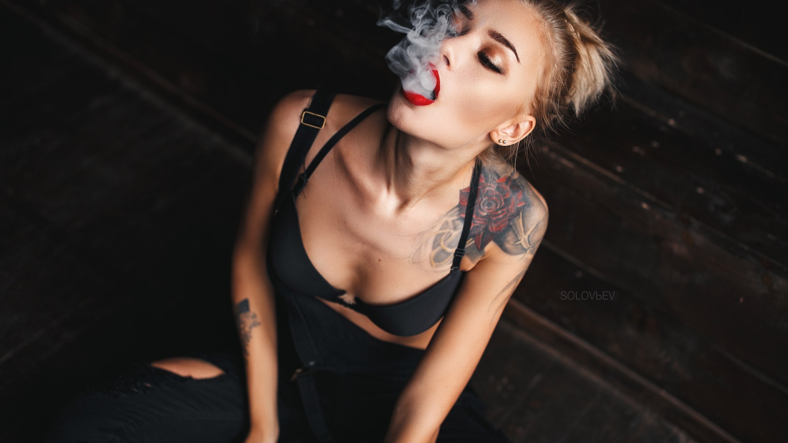 alina ostraya, women, tanned, smoke, tattoo, black bras, red lipstick, sitting, overalls, blonde, open mouth