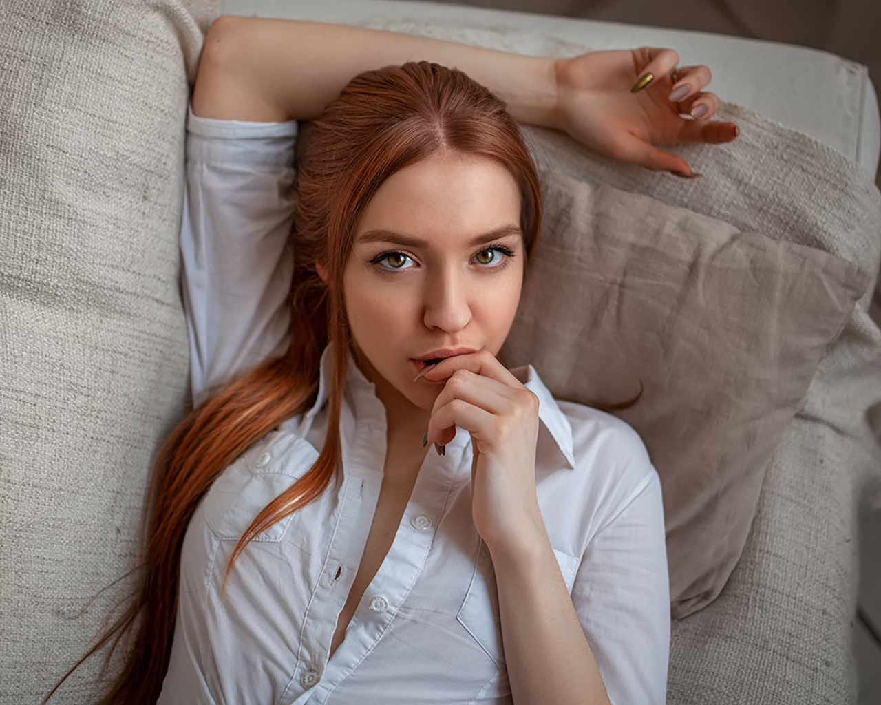 women, face, portrait, redhead, white shirt, finger on lips, painted nails, long hair, couch, top view