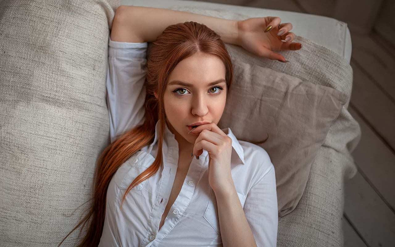 women, face, portrait, redhead, white shirt, finger on lips, painted nails, long hair, couch, top view