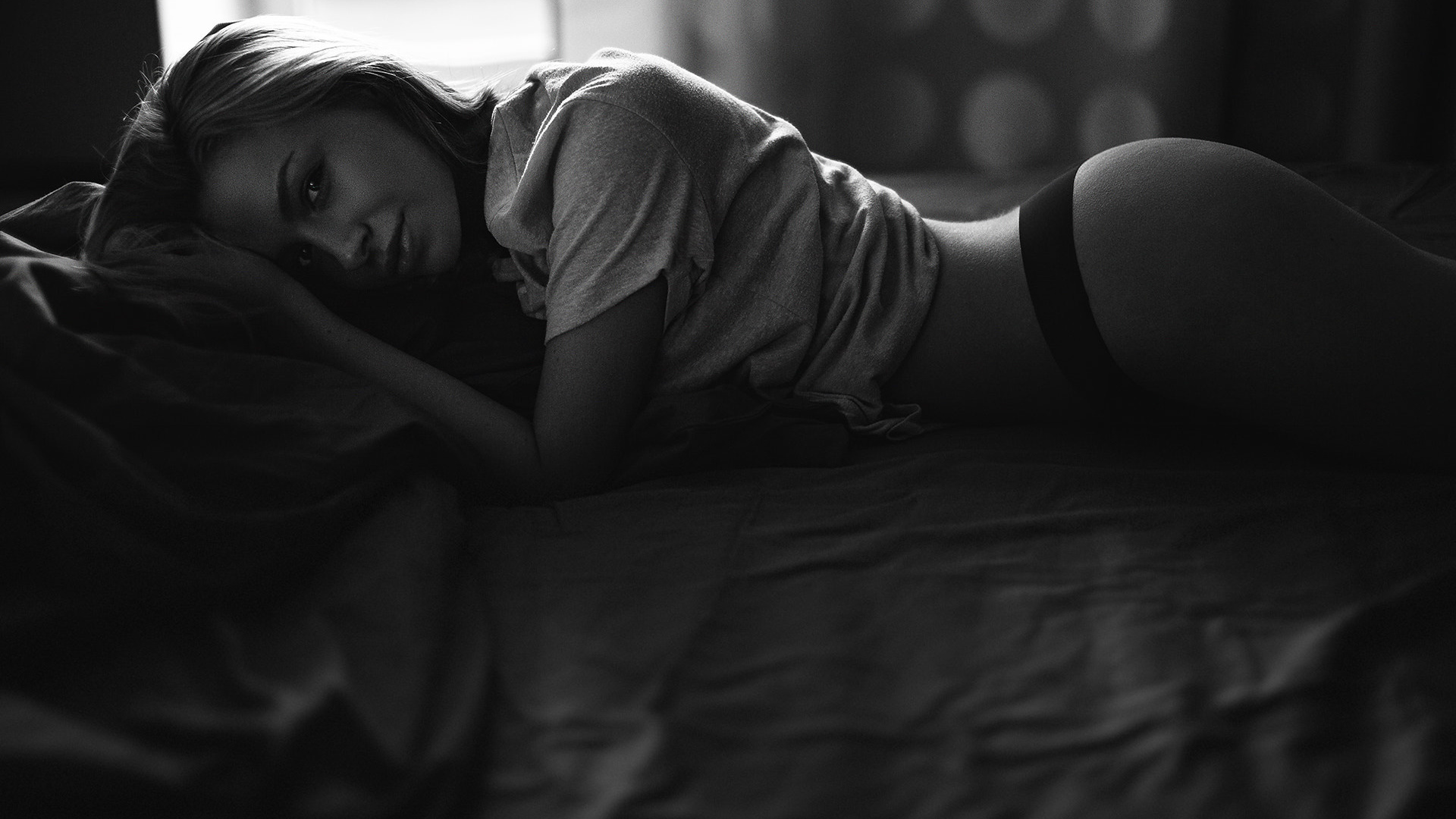 women, smiling, black panties, in bed, t-shirt, ass, lying on front, monochrome