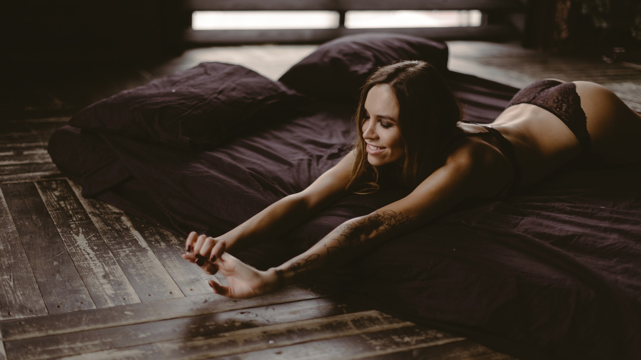 women, lying on front, closed eyes, ass, tanned, red nails, lingerie, pillow, wooden surface, tattoo