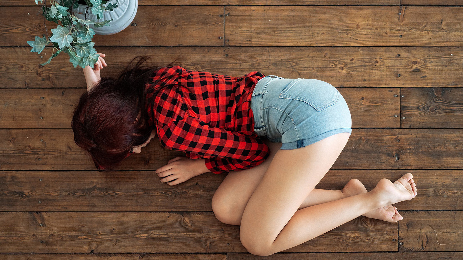 women, plaid shirt, brunette, jean shorts, on the floor, top view, wooden surface, plants