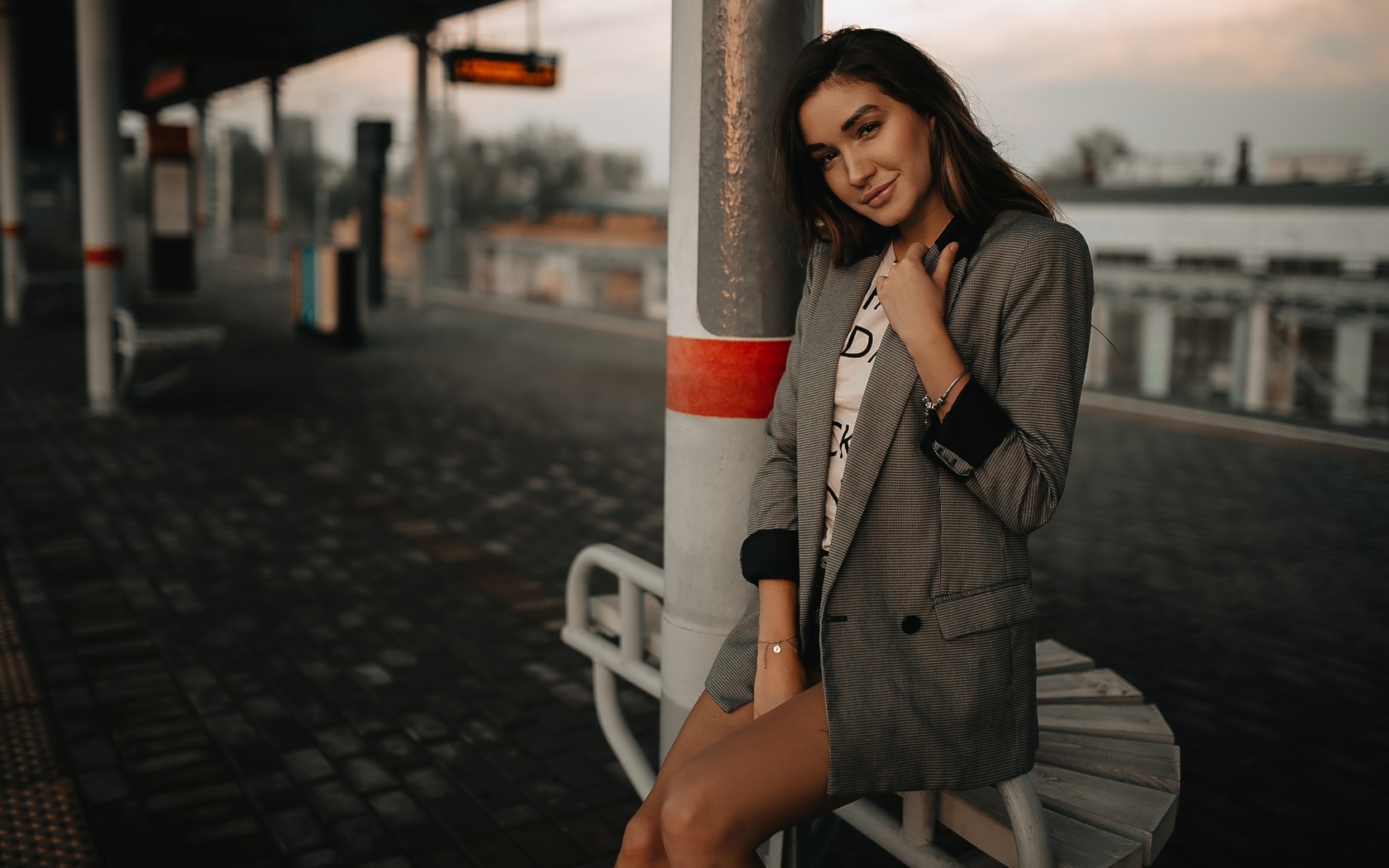 women, tanned, train station, portrait, jean shorts, smiling