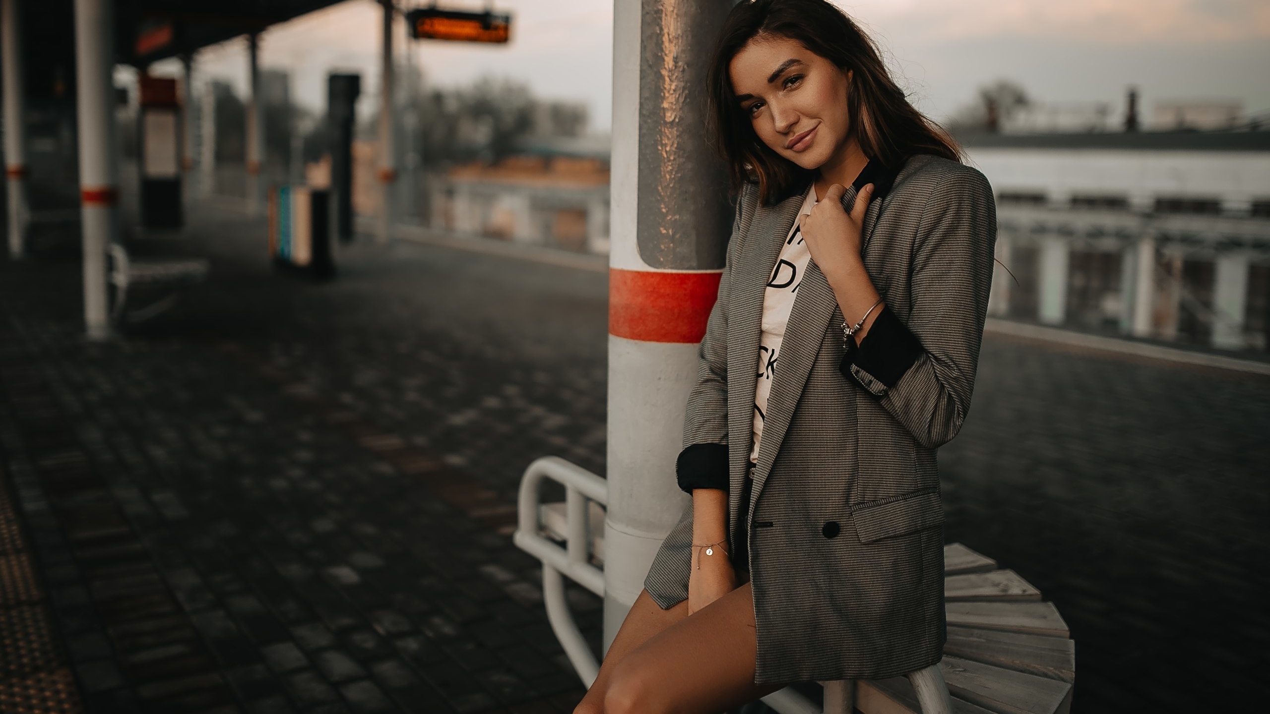 women, tanned, train station, portrait, jean shorts, smiling