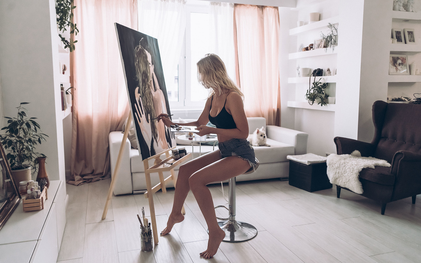 women, easel, blonde, sitting, jean shorts, dog, couch, plants, window, chair