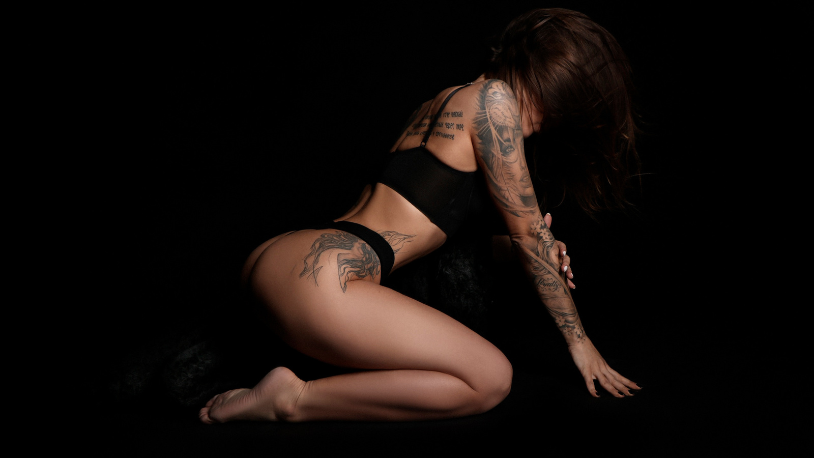 women, black lingerie, brunette, kneeling, ass, black background, painted nails, hair in face, tattoo