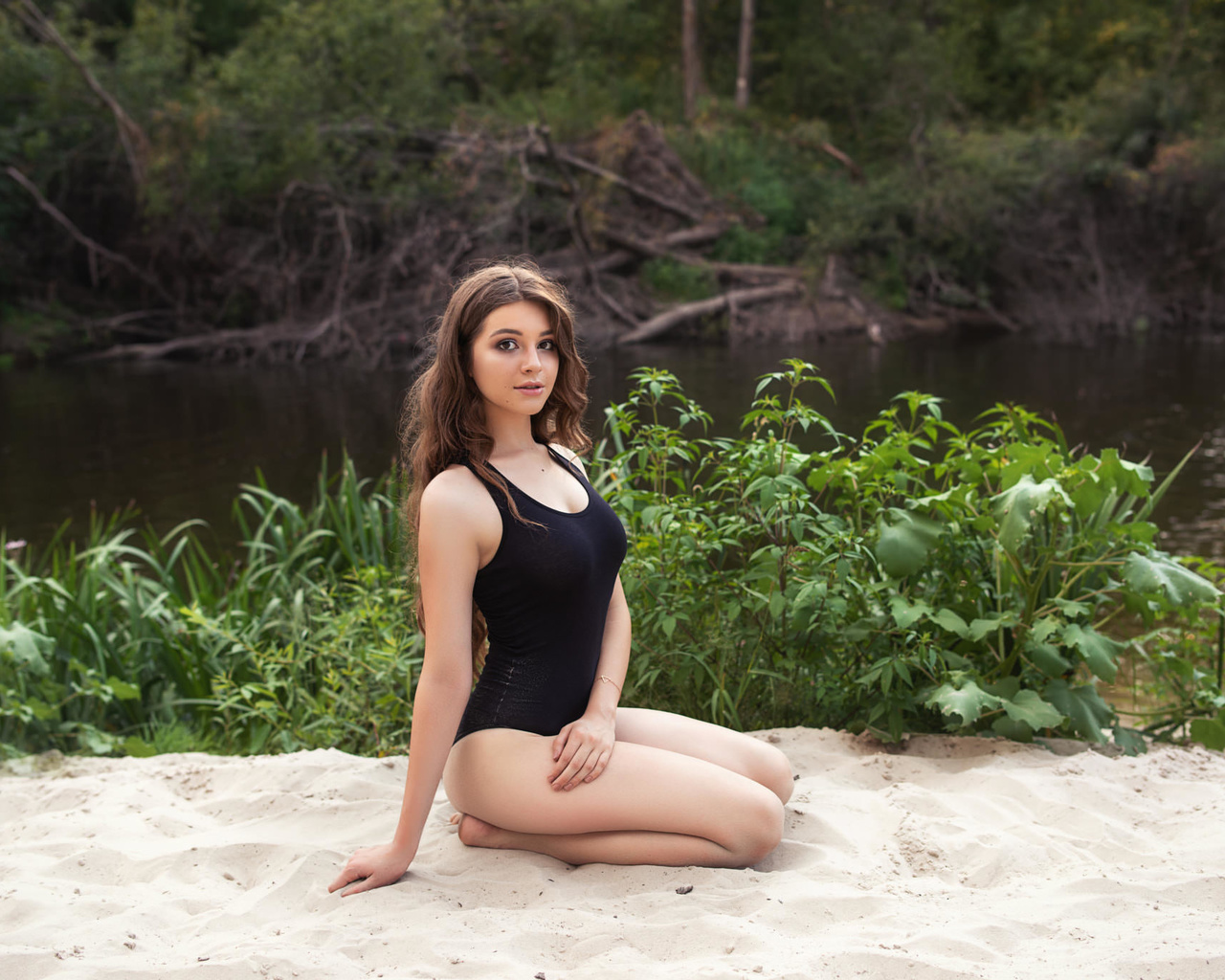 women, sand, river, one-piece swimsuit, kneeling, women outdoors, looking at viewer