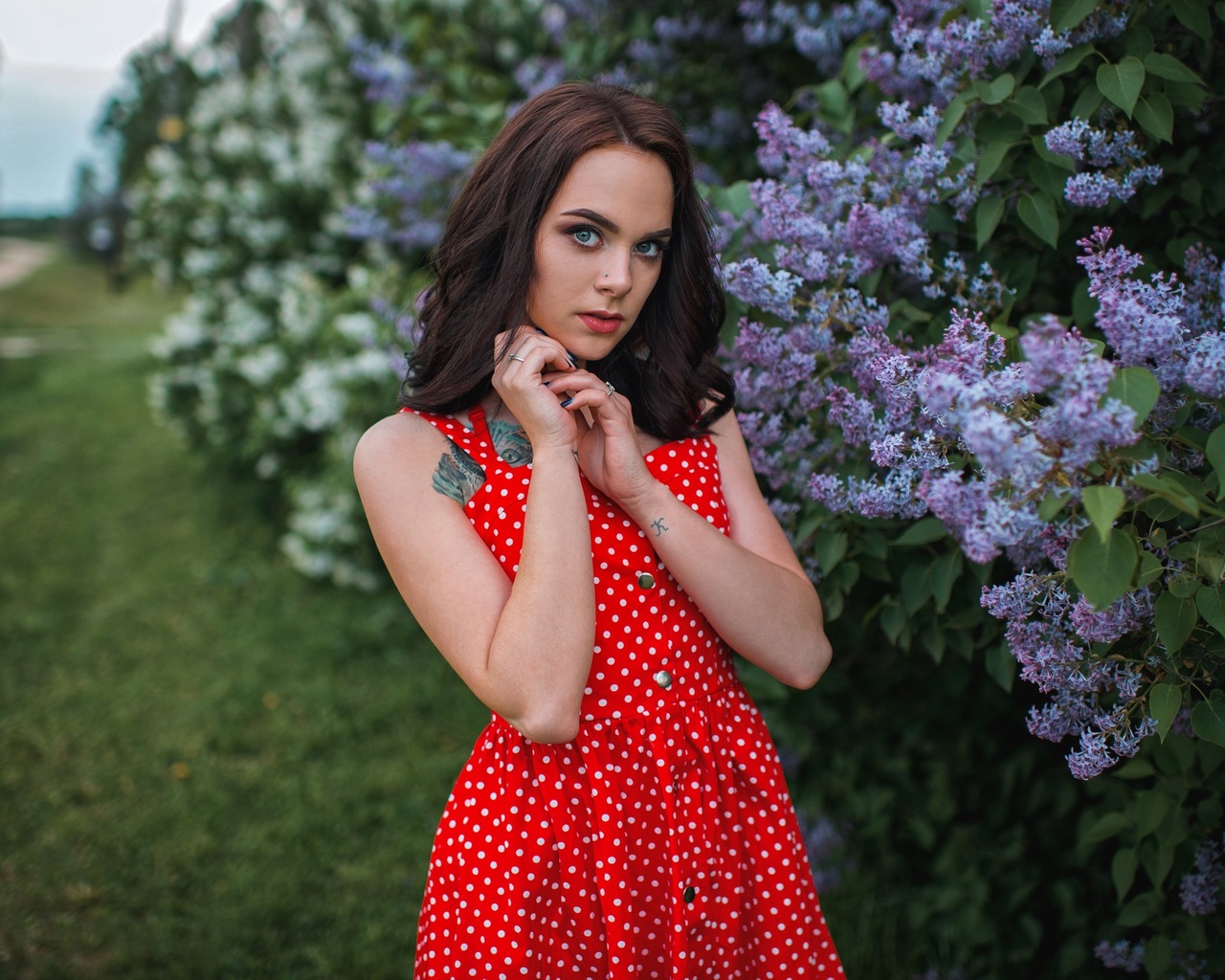 women, red dress, polka dots, women outdoors, tattoo, blue eyes, grass, blue nails, pierced nose, gray eyes, red lipstick, portrait, face