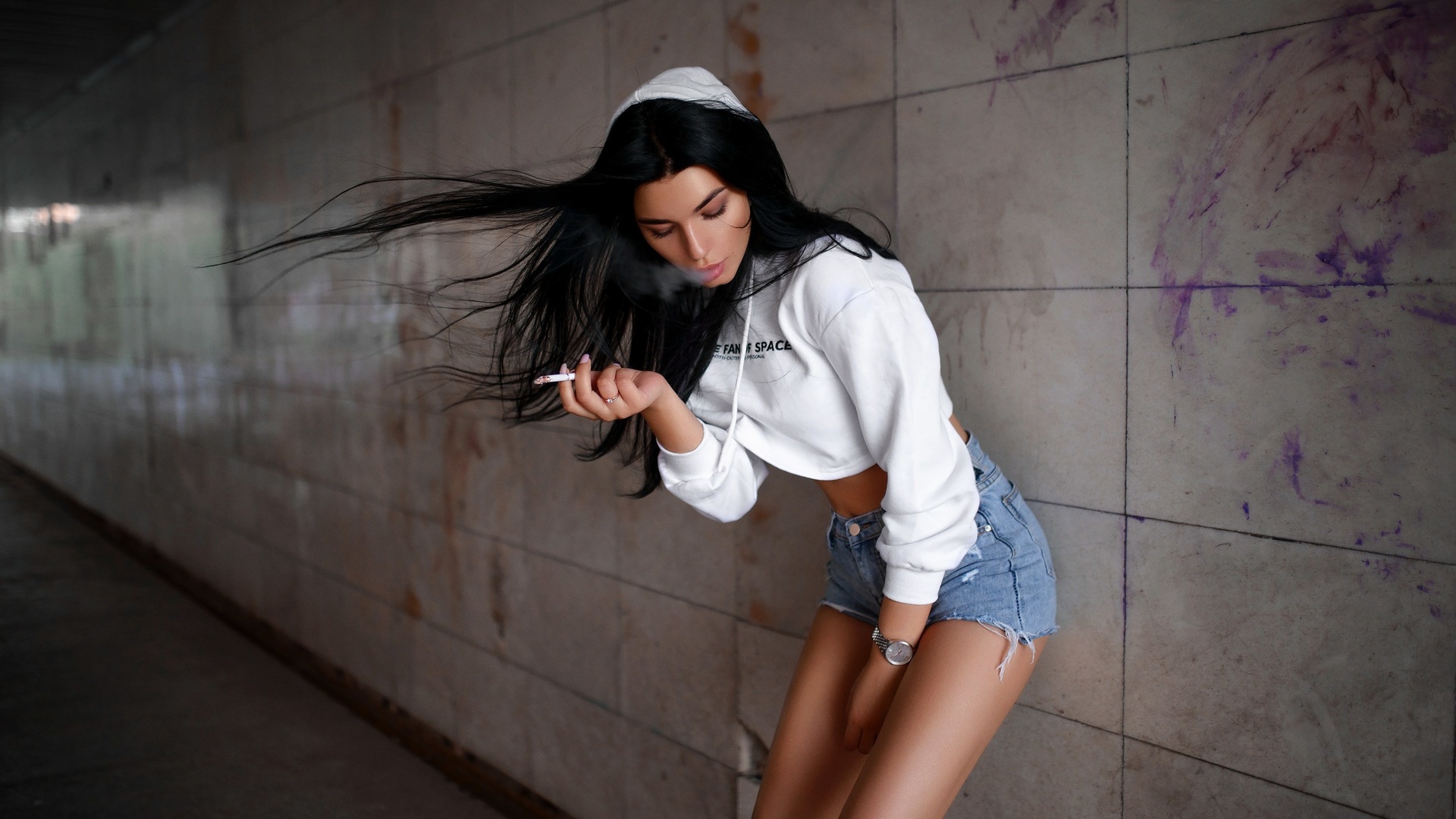 women, brunette, jean shorts, hoods, sweater, black hair, cigarettes, watch, straight hair, smoke, pink nails, closed eyes, wall