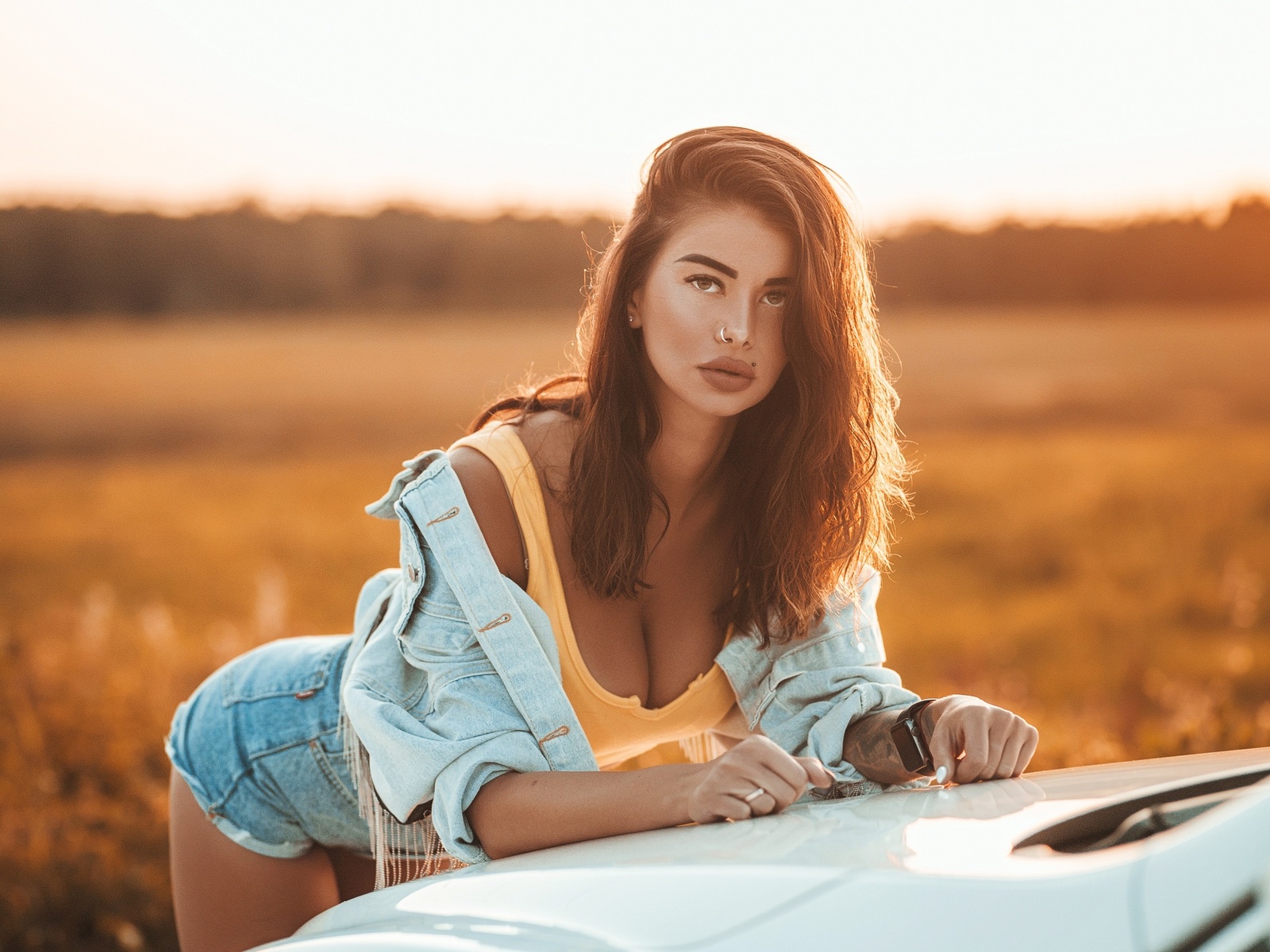 women, brunette, women outdoors, women with cars, tattoo, denim, tank top, jean shorts, sunset, nose ring, piercing, watch, juicy lips