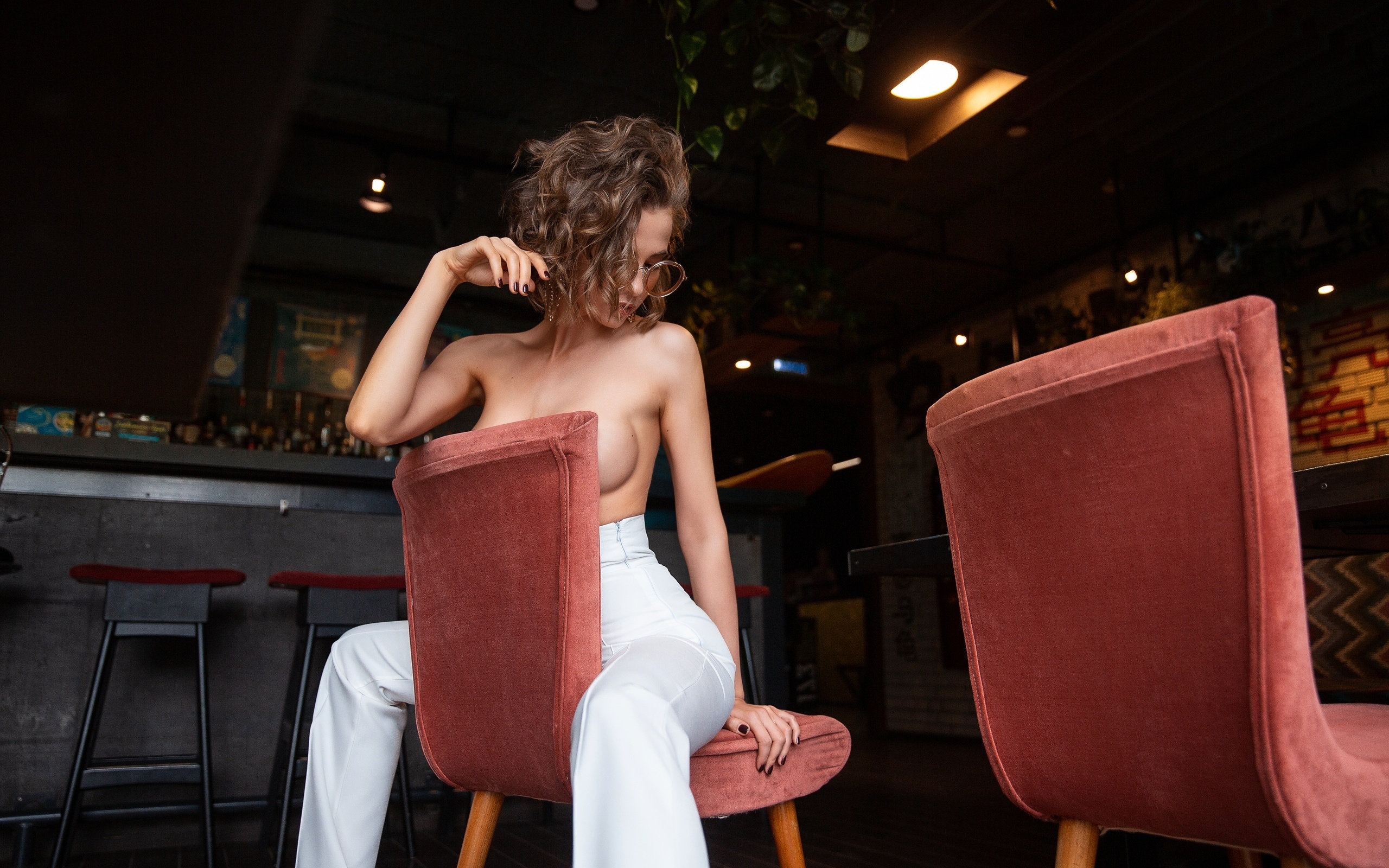 women, topless, boobs, women with glasses, pants, chair, sitting, brunette, painted nails, strategic covering