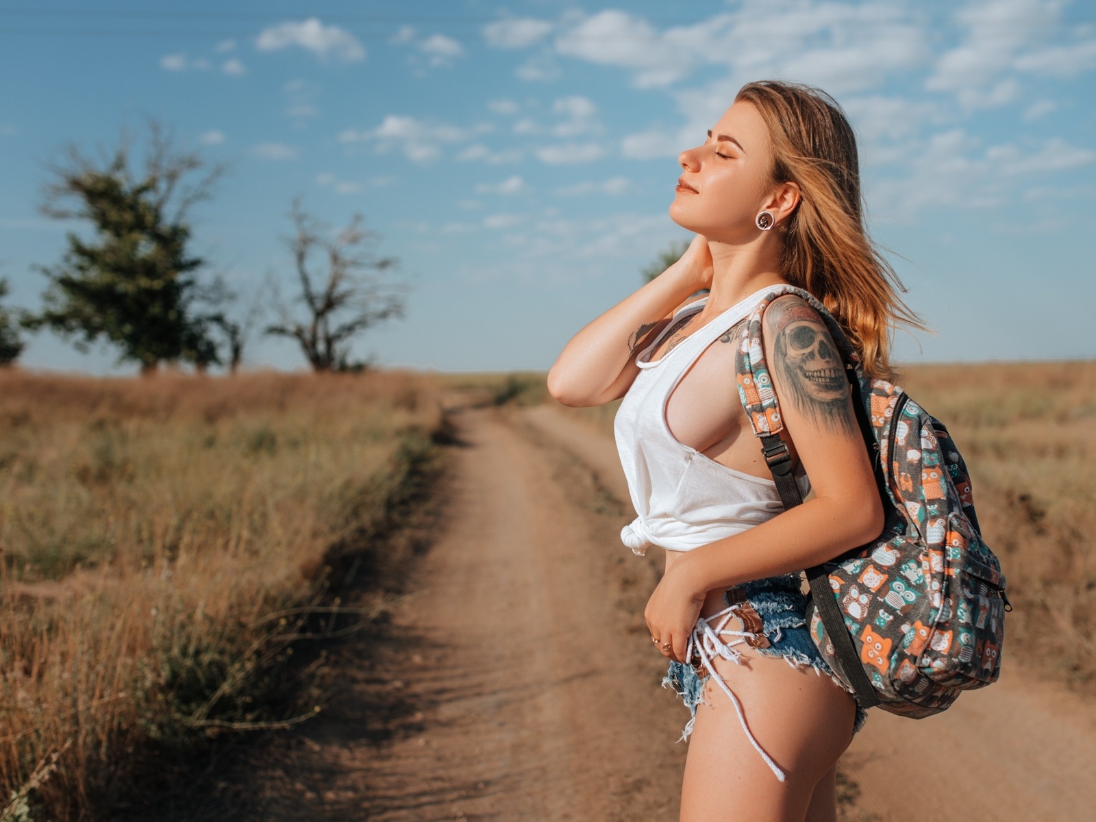 women, handbags, blonde, jean shorts, road, women outdoors, tank top, sky, clouds, closed eyes, tattoo, sideboob, ass, brunette, trees, boobs