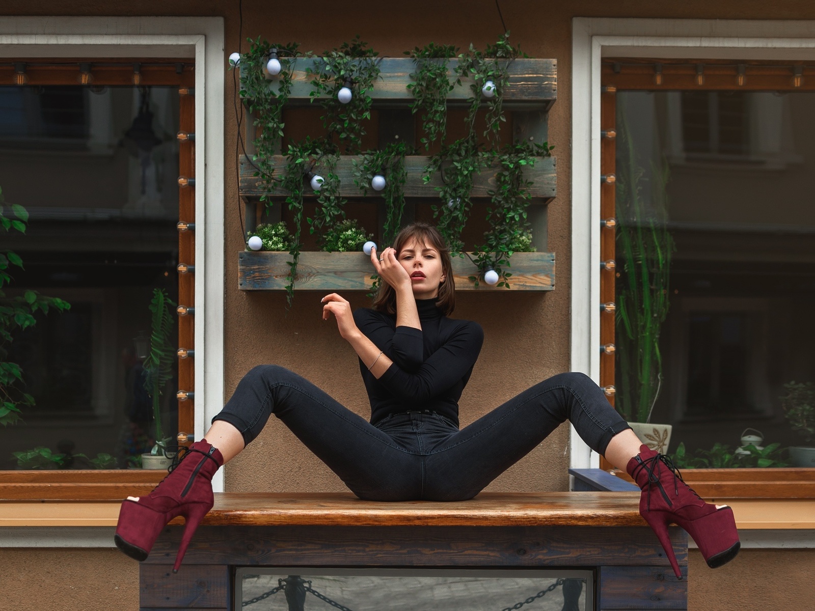 women, sitting, jeans, spread legs, black clothing, window, high heels, plants, red lipstick, table