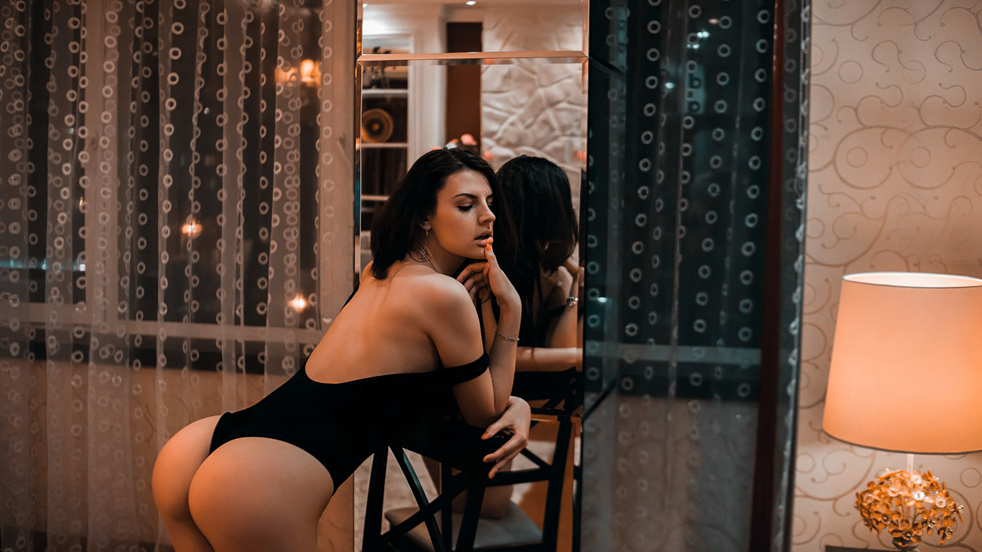 women, ass, lamp, mirror, reflection, window, bodysuit, finger on lips, women indoors, painted nails, chair