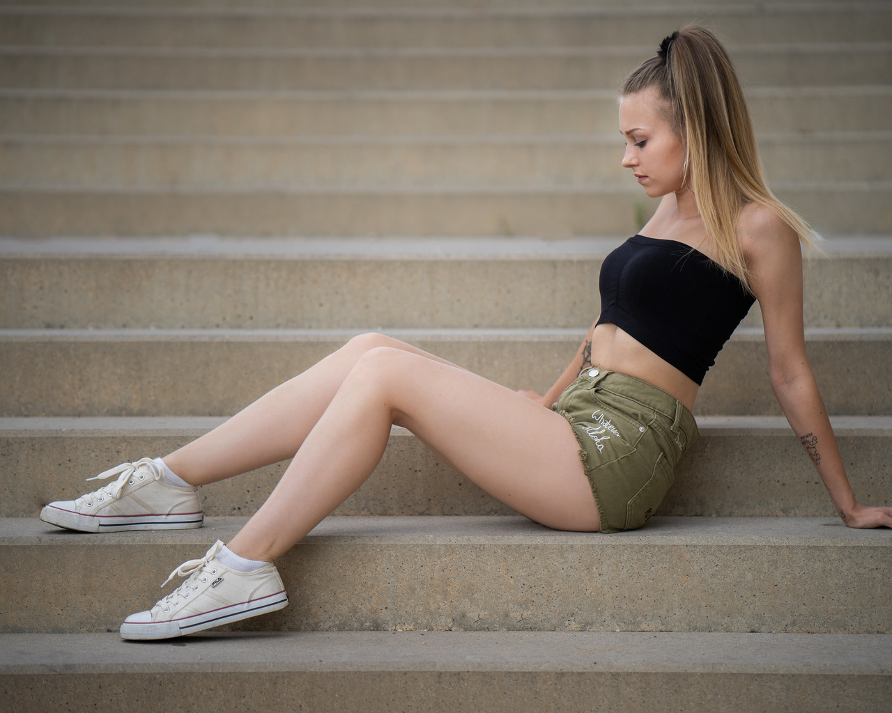 women, sitting, jean shorts, ponytail, stairs, blonde, white socks, sneakers, fila, tattoo, hoop earrings