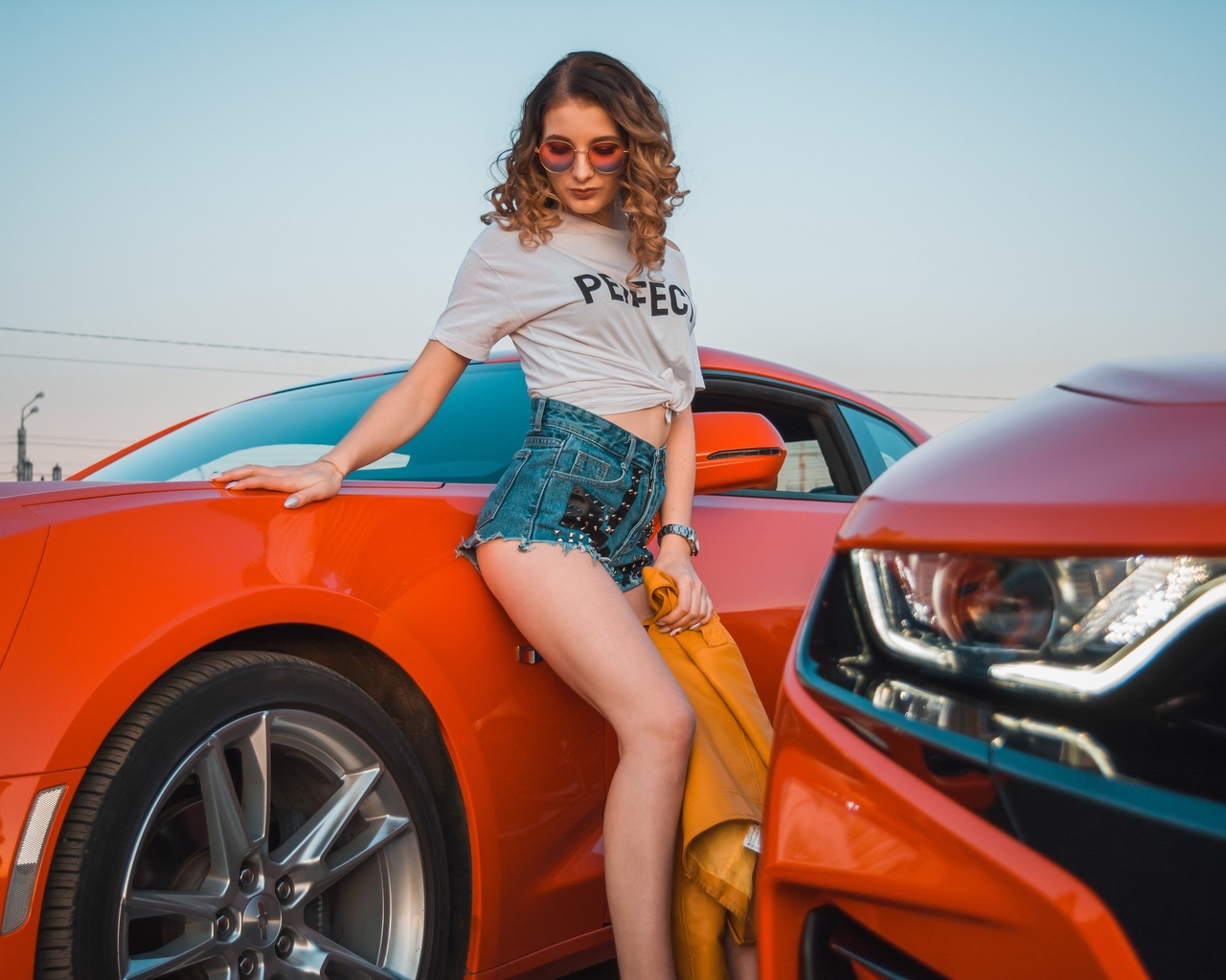 women, women with cars, jean shorts, white t-shirt, watch, women outdoors, curly hair, sky, chevrolet