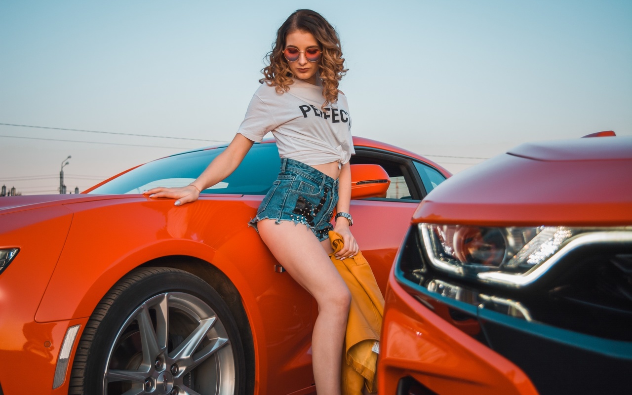 women, women with cars, jean shorts, white t-shirt, watch, women outdoors, curly hair, sky, chevrolet