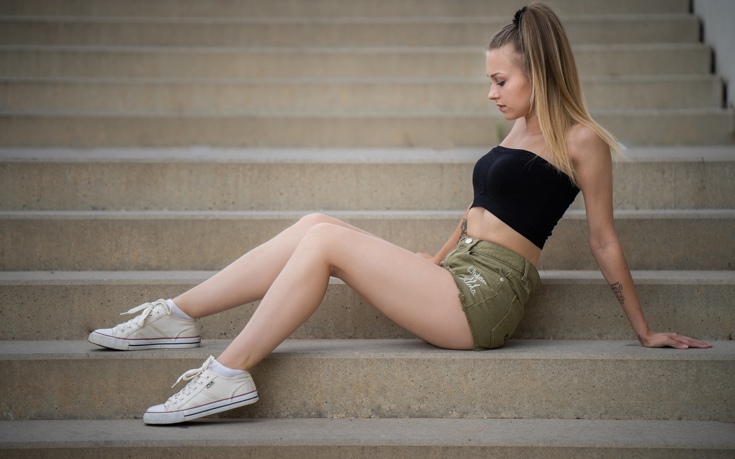 women, sitting, jean shorts, ponytail, stairs, blonde, white socks, sneakers, fila, tattoo, hoop earrings