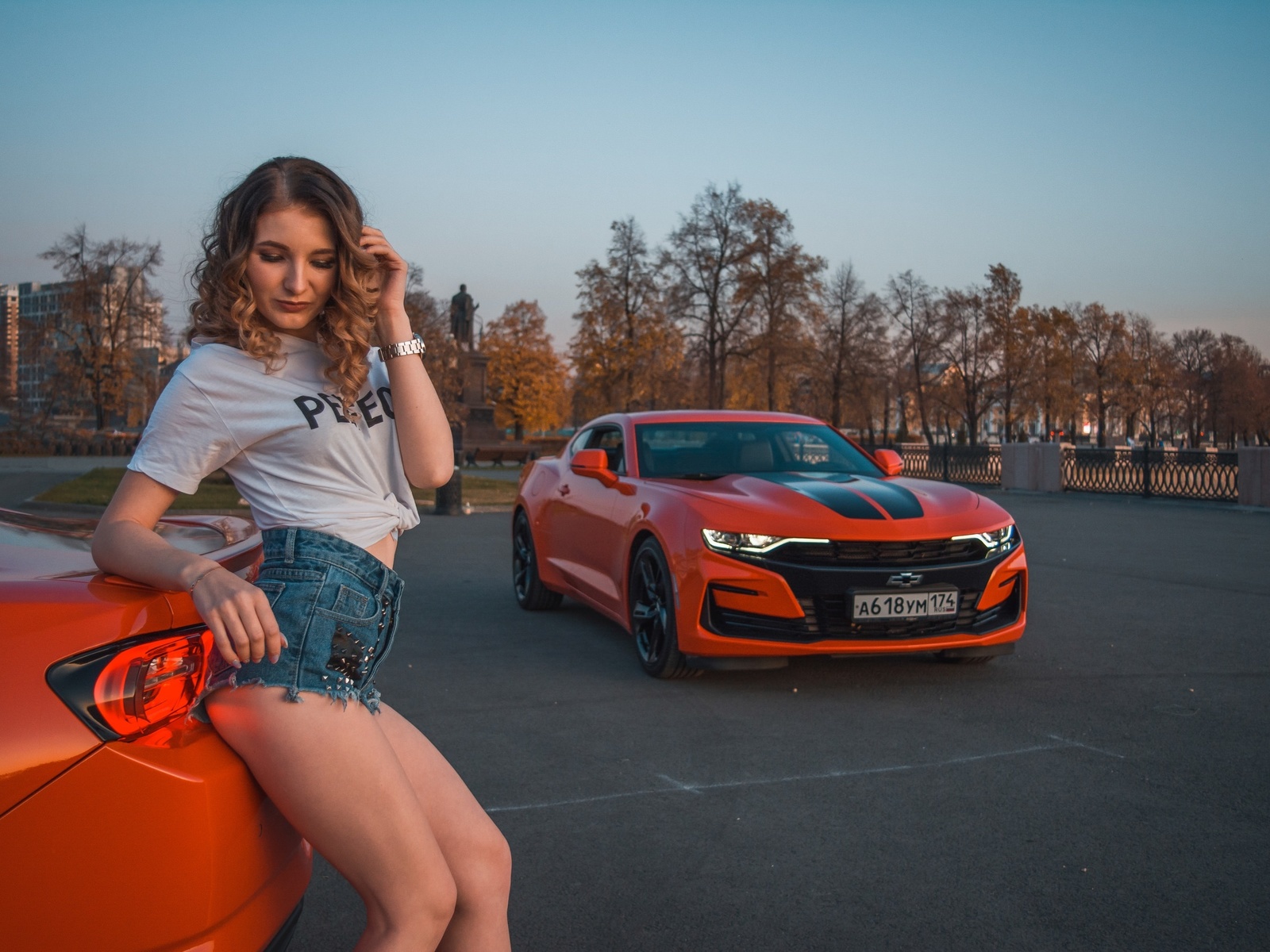 women, women with cars, curly hair, trees, sky, women outdoors, building, white t-shirt, watch, moon, chevrolet