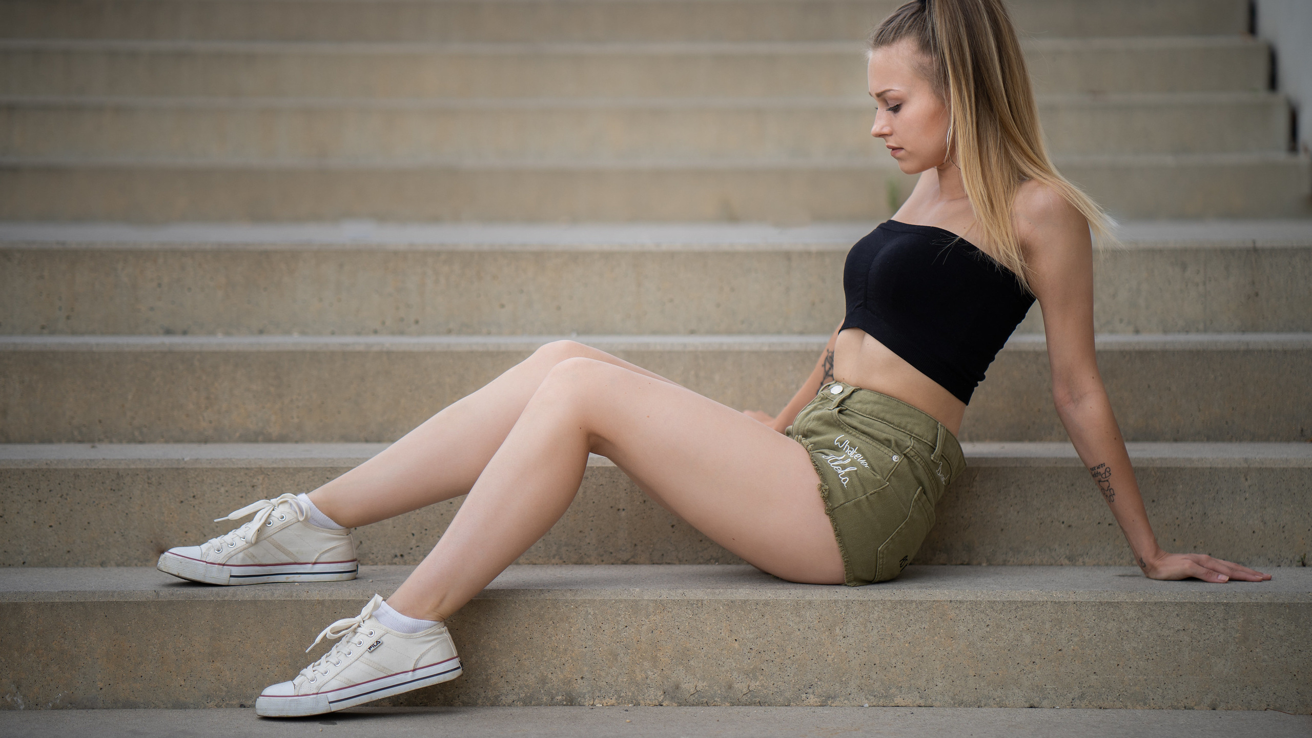 women, sitting, jean shorts, ponytail, stairs, blonde, white socks, sneakers, fila, tattoo, hoop earrings