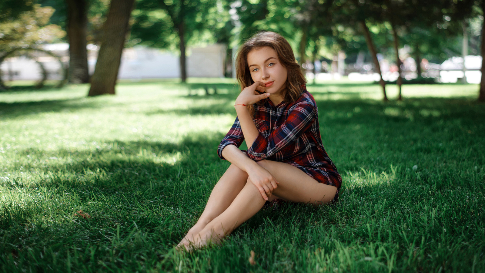 women, sitting, grass, women outdoors, finger on lips, plaid shirt, trees